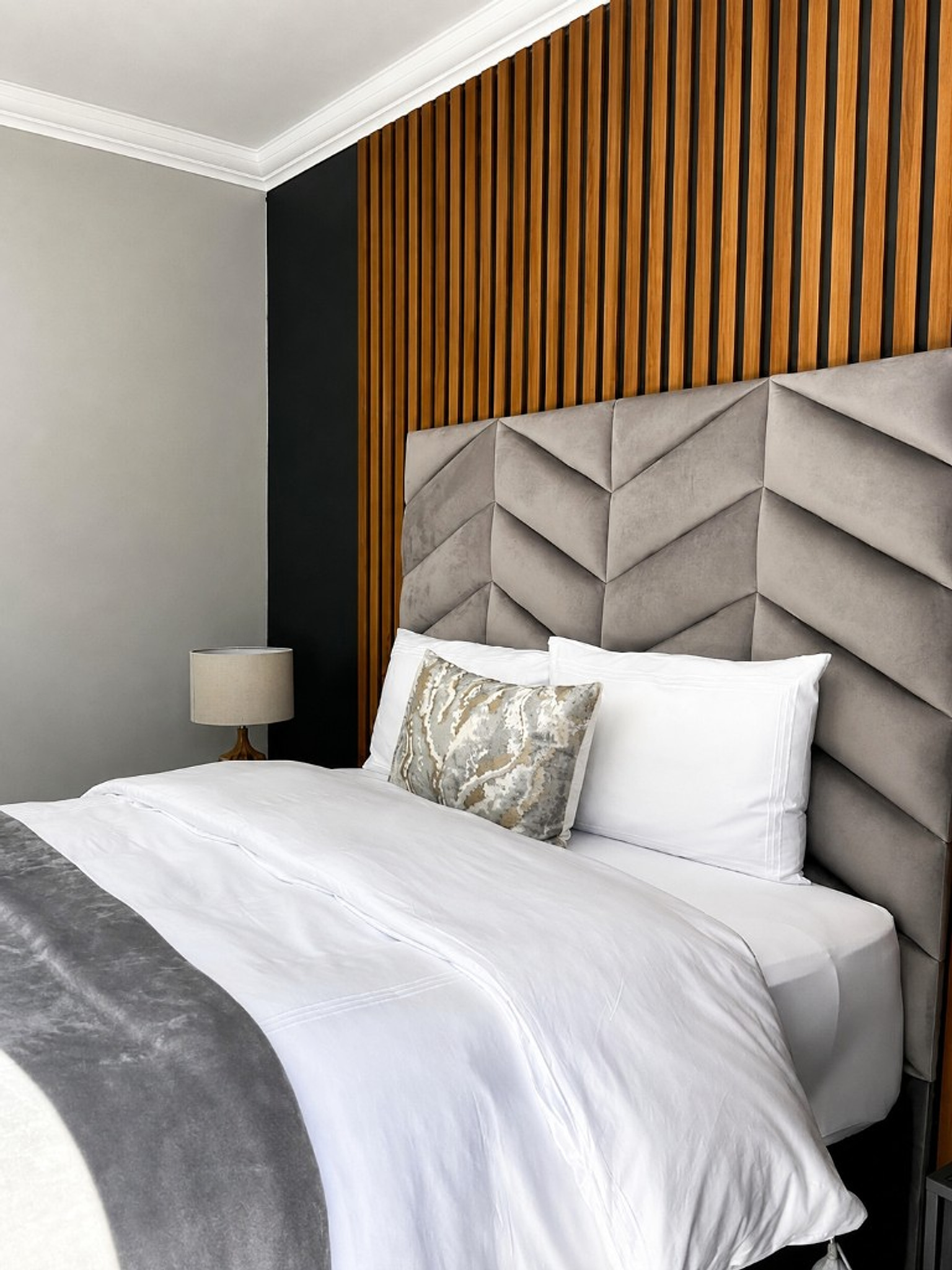 Chevron headboard bedroom against warm wood slats