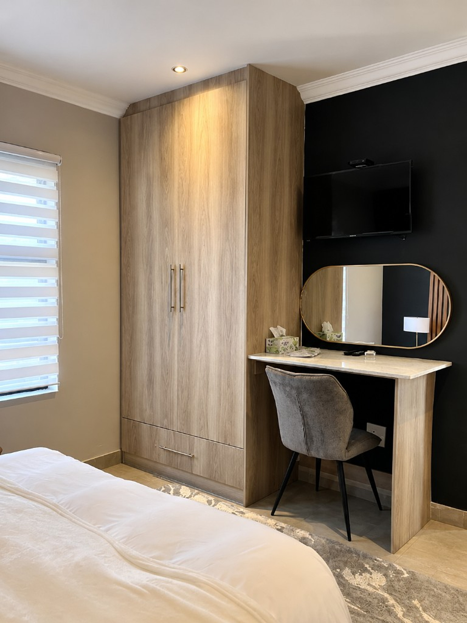 Built-in wardrobe and gold-mirror desk nook