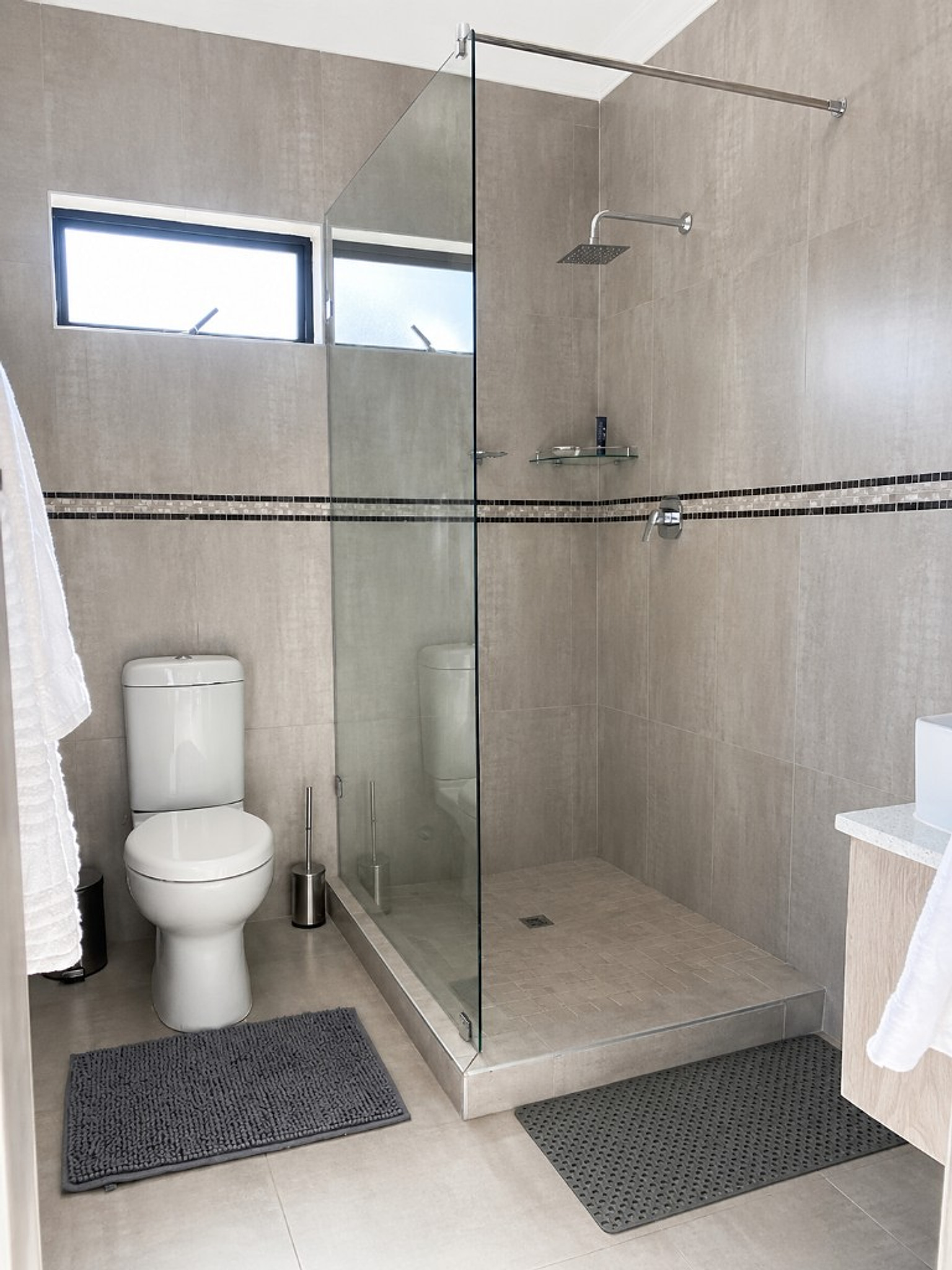 Bright ensuite bathroom with rainfall shower